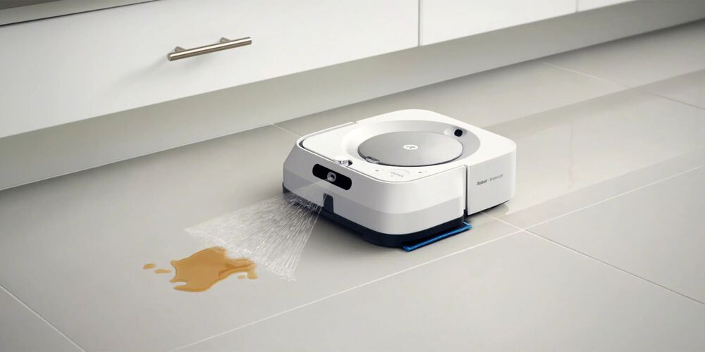 An m6 Roomba cleaning liquid off a floor